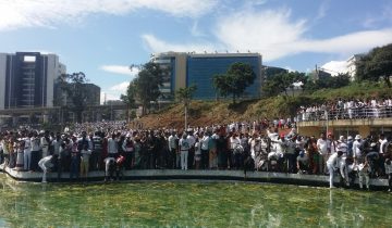 Crowds celebrating Irreecha thanksgiving festival beside a lake