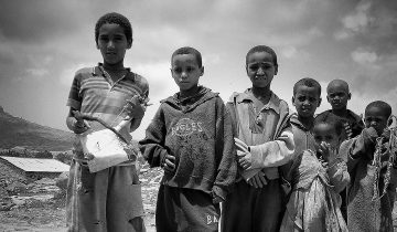 Young musician holds a masenqo, the one-string fiddle of Azmari tradition, in Tigray, Ethiopia