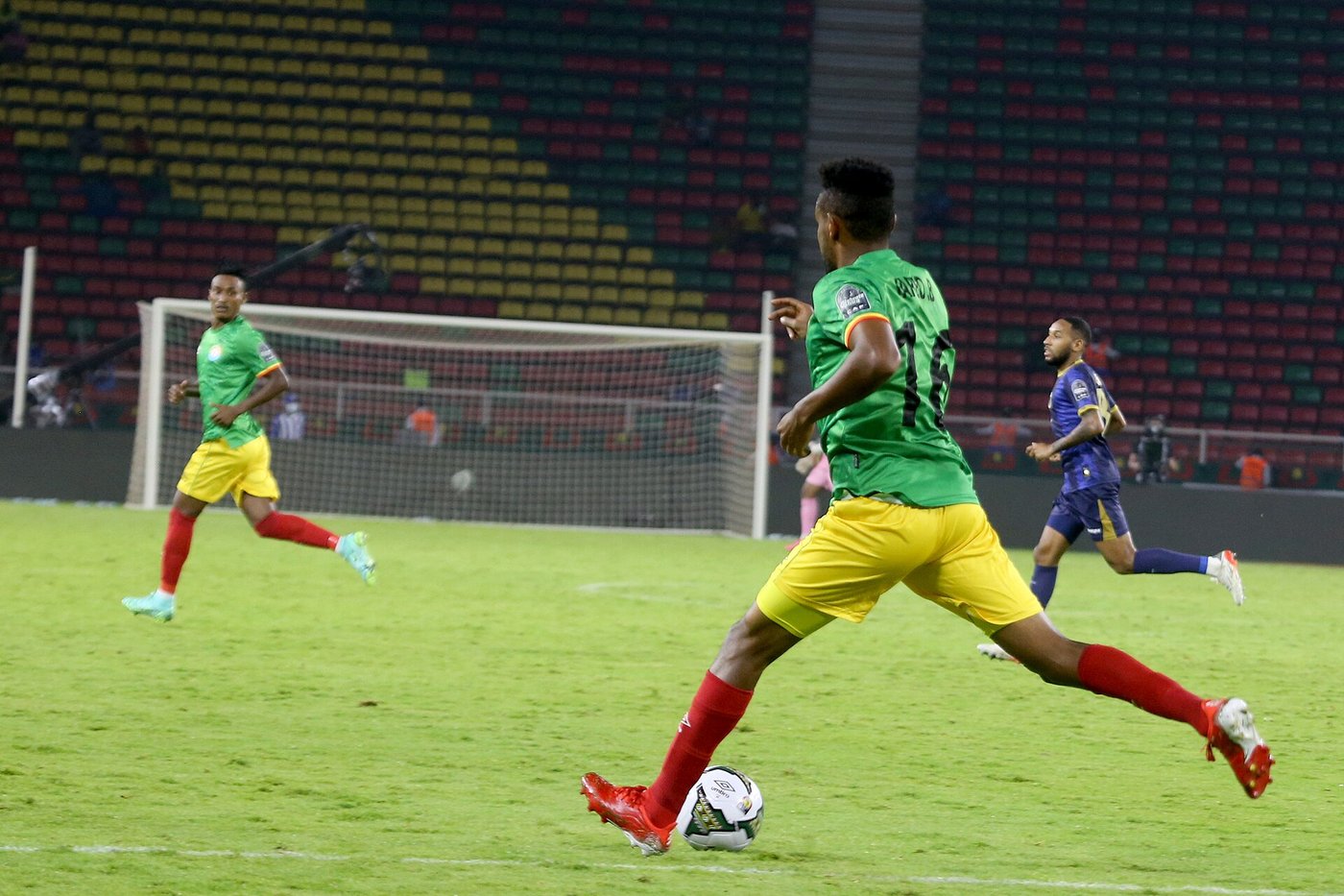 An Ethiopia player in a green shirt and yellow shorts runs with the ball during a match against Cape Verde at the 2021 Africa Cup of Nations in Yaoundé, Cameroon