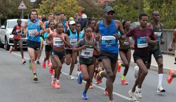 Ethiopian women runners with bibs reading Mare, Abebech and Bedatu run with male pacemakers on a street at the 2018 Frankfurt Marathon